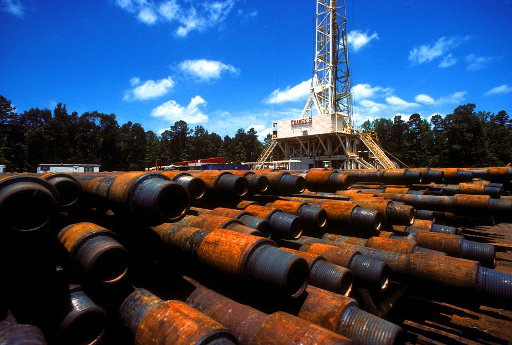 Stacks of steel casing at a wellsite