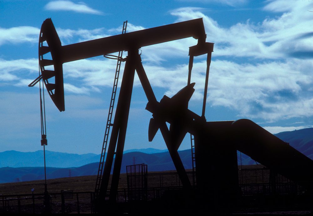 Pump jack against a blue sky