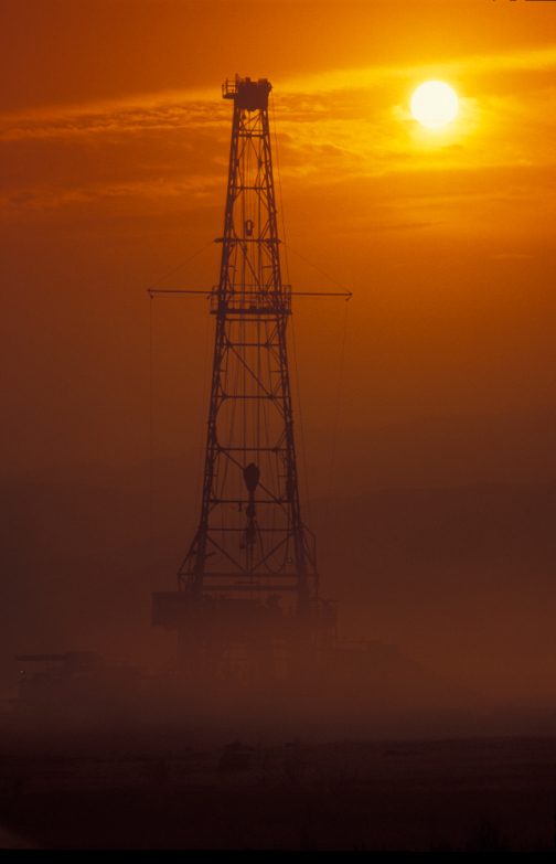 Drilling rig in fog at dawn